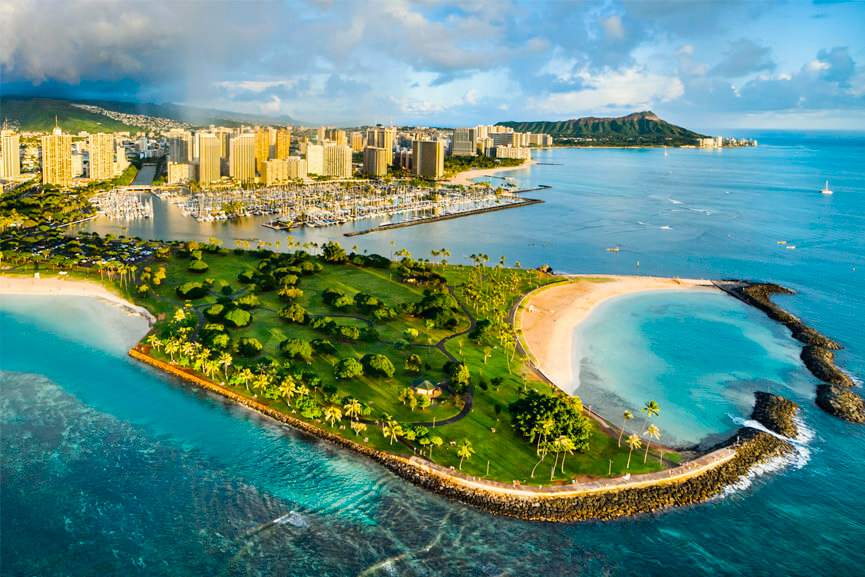 A Rainbow Helicopters Tour Flying Towards The Magic Island Lagoon And The Oahu Skyline With Diamond Head In The Background